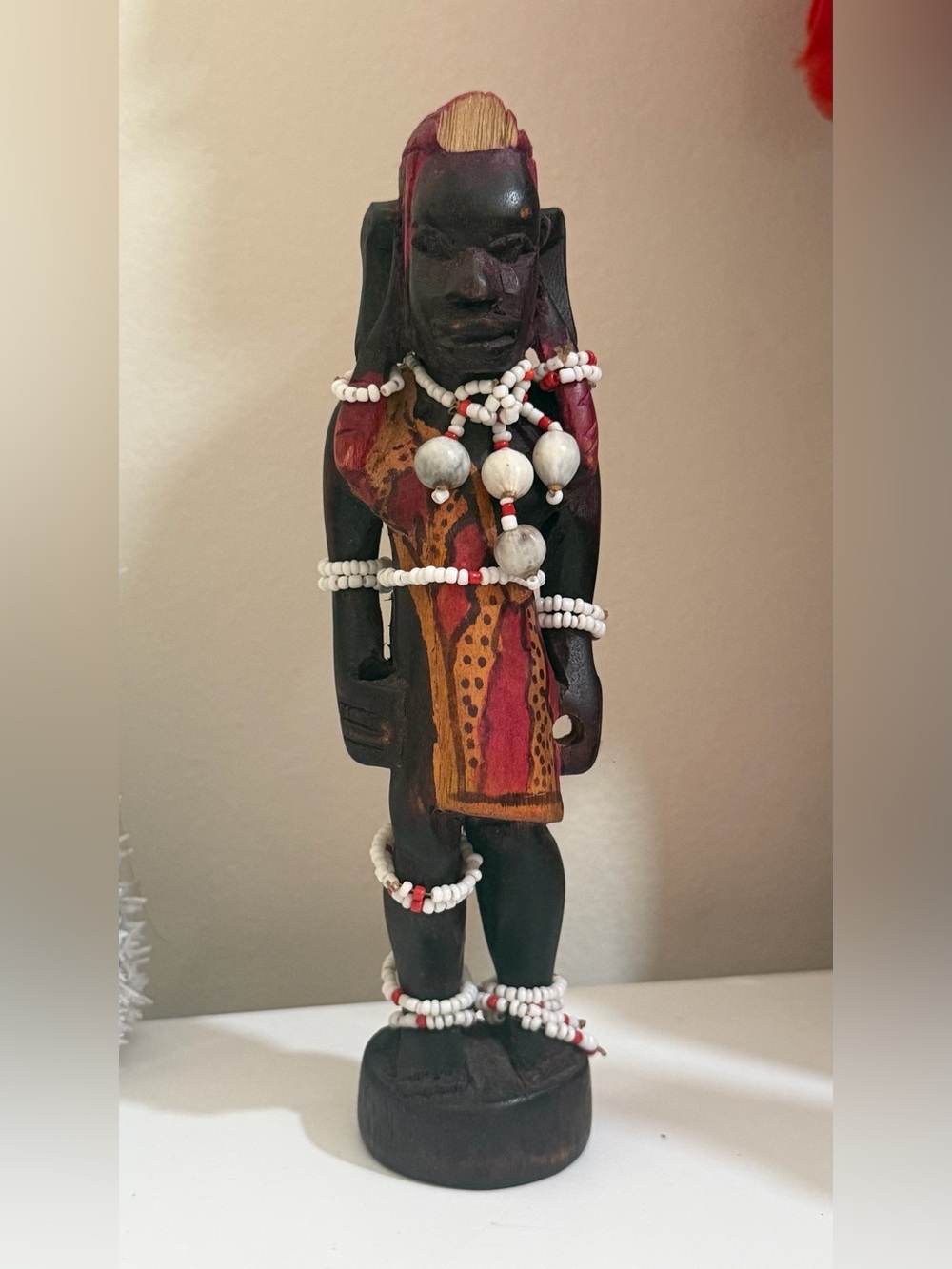Hand-Carved Black Wooden Tribal Figure with Red and Yellow Accents